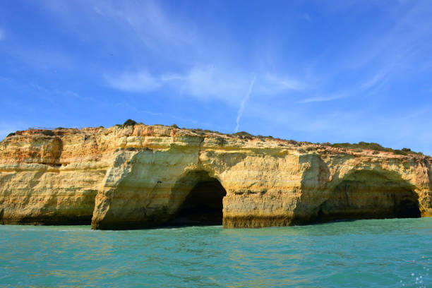 Benagil Cave (Algar de Benagil) seen from the Atlantic, Lagoa, Algarve, Portugal Lagoa, Algarve / Faro district, Portugal: arches of Benagil Cave - a grotto created by the erosion of the colourful sedimentary rocks by the waters of the Atlantic Ocean, creating a dome and several arches, like a cathedral - Algar de Benagil. benagil photos stock pictures, royalty-free photos & images