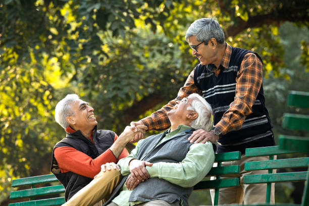 istock Senior male friends having fun at park 1295301505