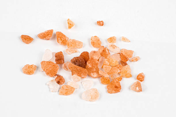 istock Pink himalayan salt on a white background with visible details 1295301555