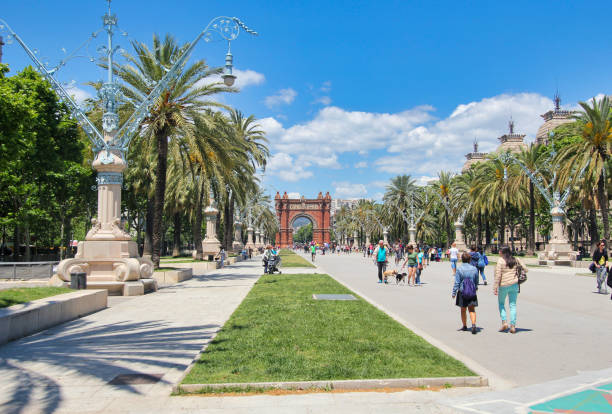 Triumphal Arch in Barcelona, Spain Barcelona, Spain - May 23, 2015: Tourists walk in front of the Arc de Triomf triumphal arch in Barcelona, Spain on May 23, 2015. arc de triomf barcelona photos stock pictures, royalty-free photos & images