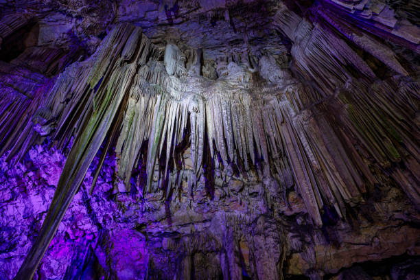 Upper Rock Nature Reserve at Gibraltar. Exploring Old St. Michaels Cave, that has been illuminated with colorful LED lighting, located at the Upper Rock Nature Reserve at Gibraltar.