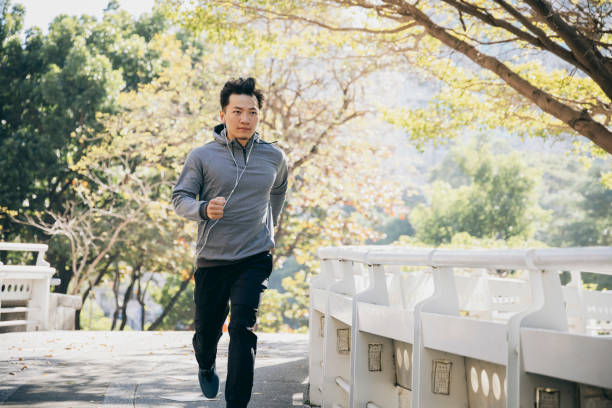 istock Man jogging in the park 1295302059