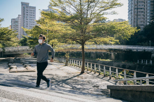 istock Man jogging in the park 1295302101