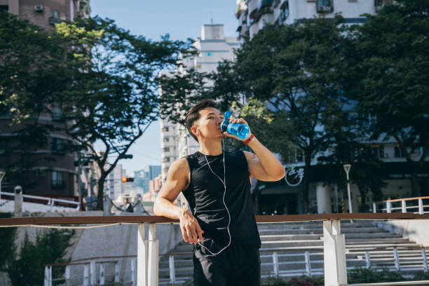 istock male athlete drinking water 1295302238
