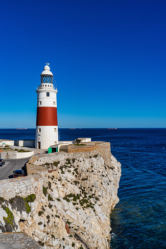 Europa Point Lighthouse, Trinity Lighthouse or Victoria Tower. Strait of Gibraltar on the background. British Overseas Territory of Gibraltar.