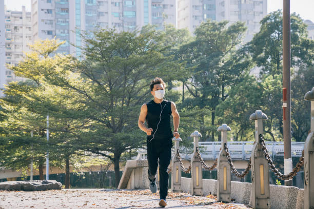 istock Man jogging in the park 1295302482