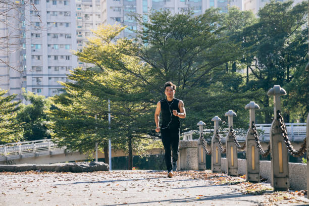 istock Man jogging in the park 1295302892