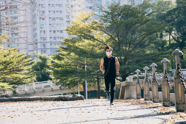 istock Man jogging in the park 1295303040