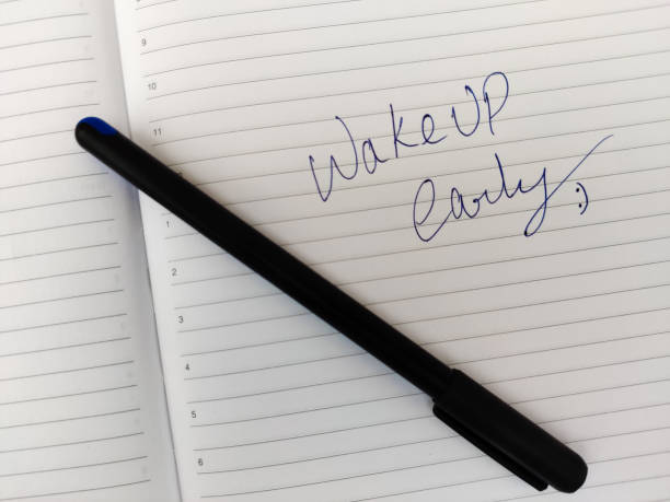 istock A Daily diary with text WAKE UP EARLY and pen. Selective focus 1295305102