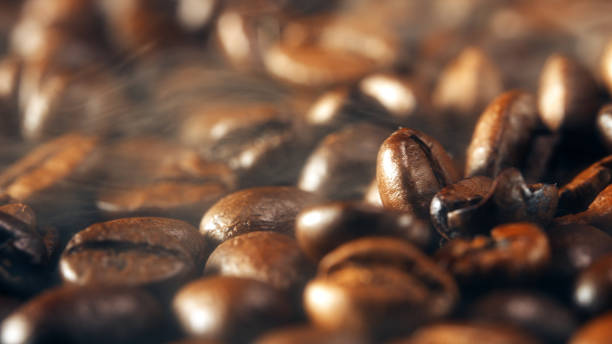 istock Freshly roasted coffee beans with smoke. 1295309123