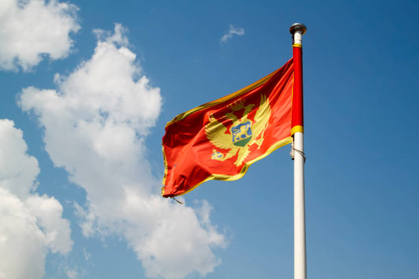 Flag of Montenegro against blue sky stock photo