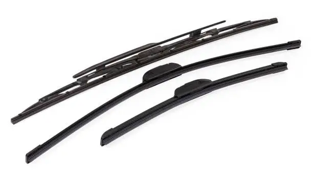 Photo of Pair of frameless windshield wipers blades against used traditional wiper