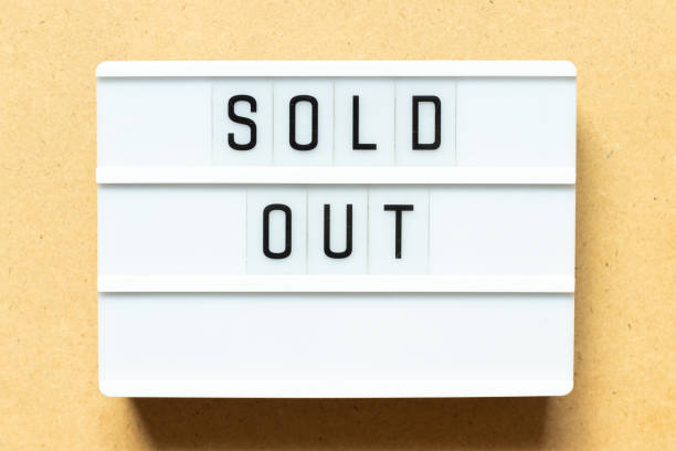 istock Lightbox with word sold out on wood background 1295312811