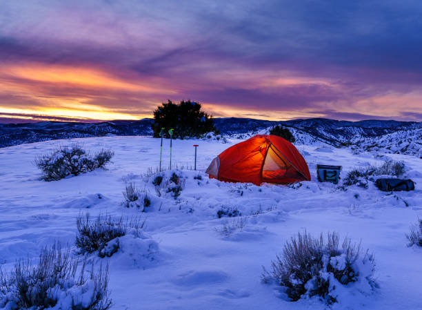 istock Shoveling Snow Winter Camping in Mountains 1295313170