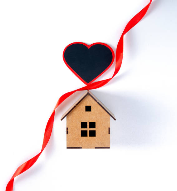 istock House with love heart red ribbon 1295314691
