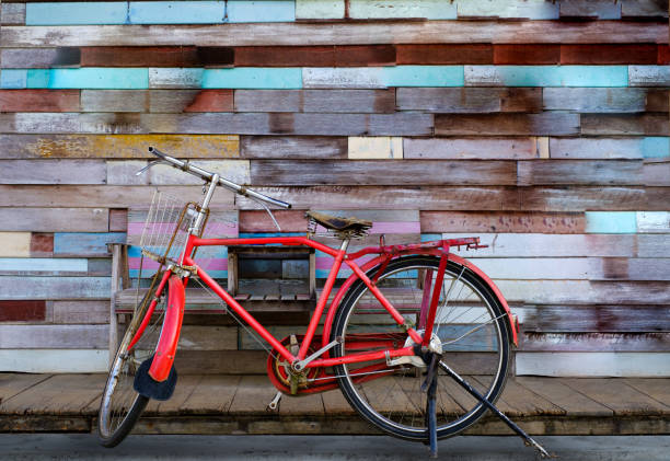 istock Vintage bicycle with old wooden background 1295314729