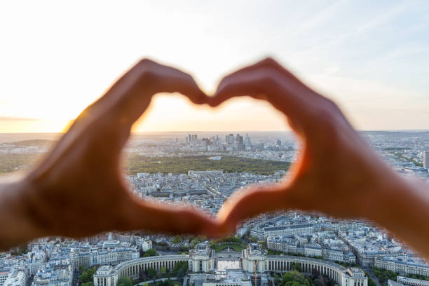 istock Couple making a heart shape with hands in Paris at sunset 1295316855