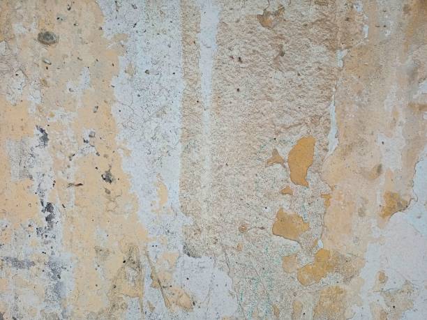 istock The old concrete wall is painted with paints. 1295319092