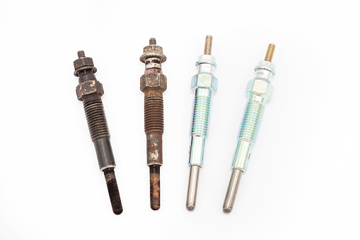 new and old glow plug for diesel engine on white background