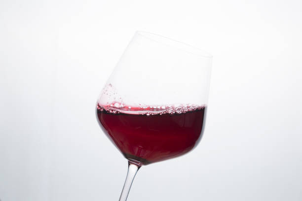 istock Red wine in a glass on a white background. 1295323568