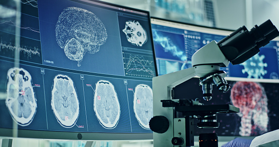 Computer screens in laboratory. Brain scans and coronavirus research