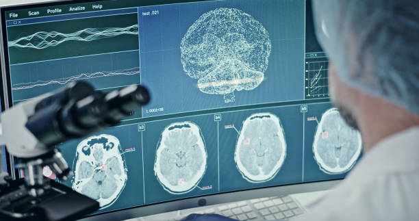 istock Laboratory equipment. Brainwave research on screens. Rear view of scientist 1295324689