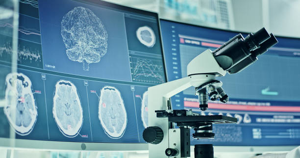 istock Laboratory equipment, microscope and computers. Brainwave research on screens. Side view of scientist 1295324804