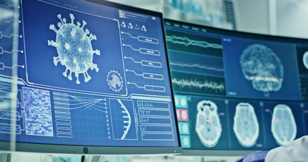 istock Laboratory equipment. Coronavirus and brainwave research on screens. Side view of scientist 1295324814