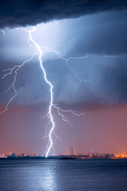 istock strong thunderstorm with lightning over the city 1295326088