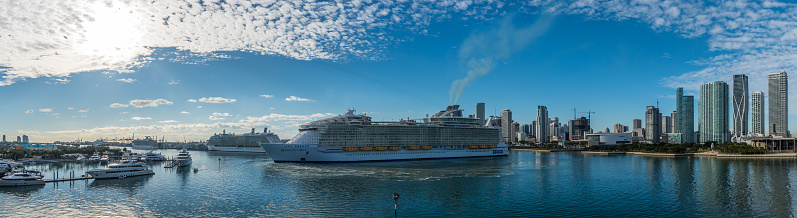 Miami, FL, USA - January 7, 2021: Panoramic view of cruise ships stopped at the port due to the global crisis of the Coronavirus epidemic (COVID-19) in the Port of Miami, one of the busiest ports in the United States.