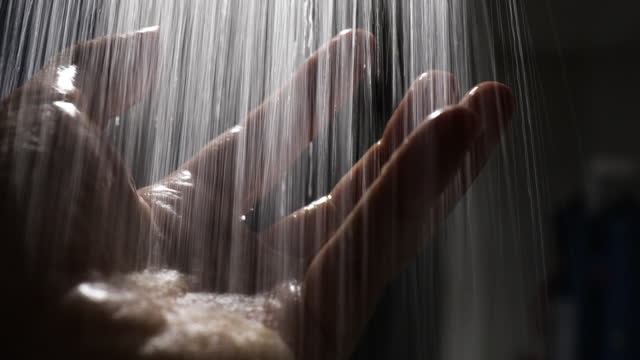 Catching water stream falling in hands