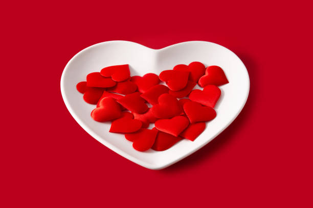 istock Heart shaped plate with red hearts inside 1295331067