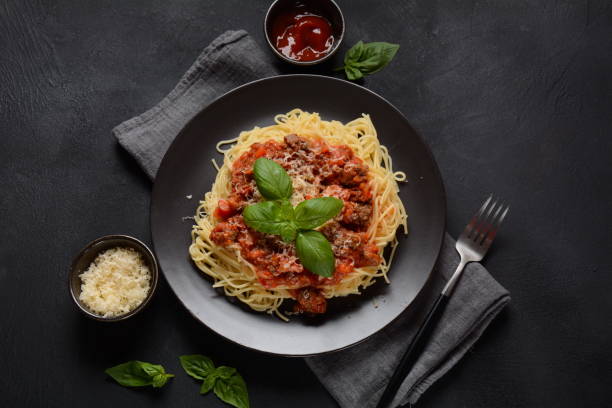 istock Plate of pasta Bolognese on dark background, 1295331466
