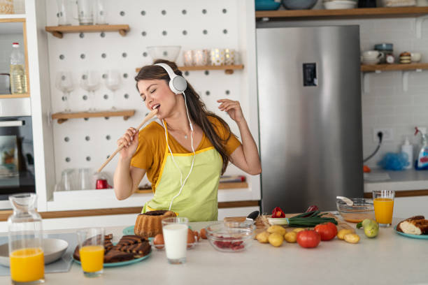 istock Young woman having fun in the kitchen 1295331495
