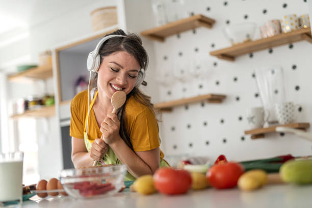 istock Young woman having fun in the kitchen 1295334968