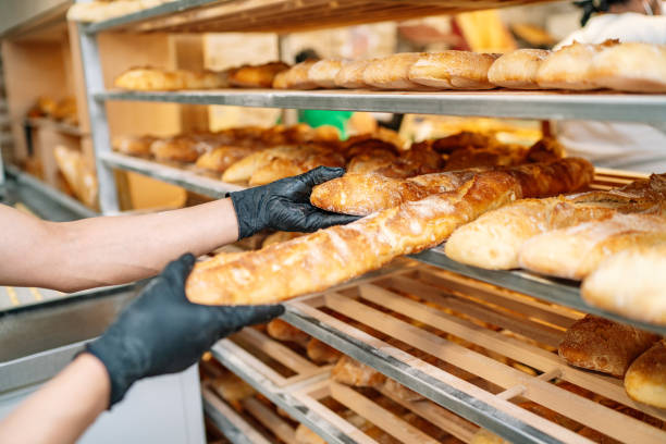 istock selective focus of baker shelving freshly baked bread 1295337302