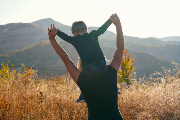 istock Happy family: mother with son nature on summer sunset 1295337357