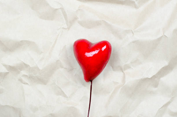 istock Two hearts on a crumpled beige background 1295338842