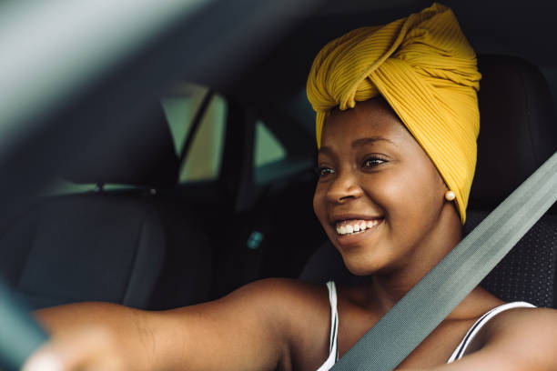 istock Happy woman driving car 1295340734