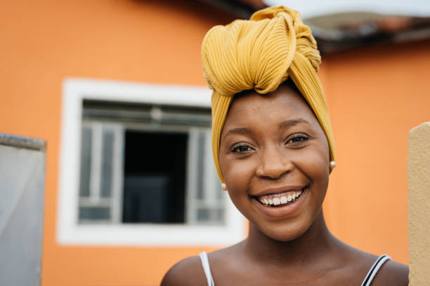 istock Smiling woman at home entrance 1295340740