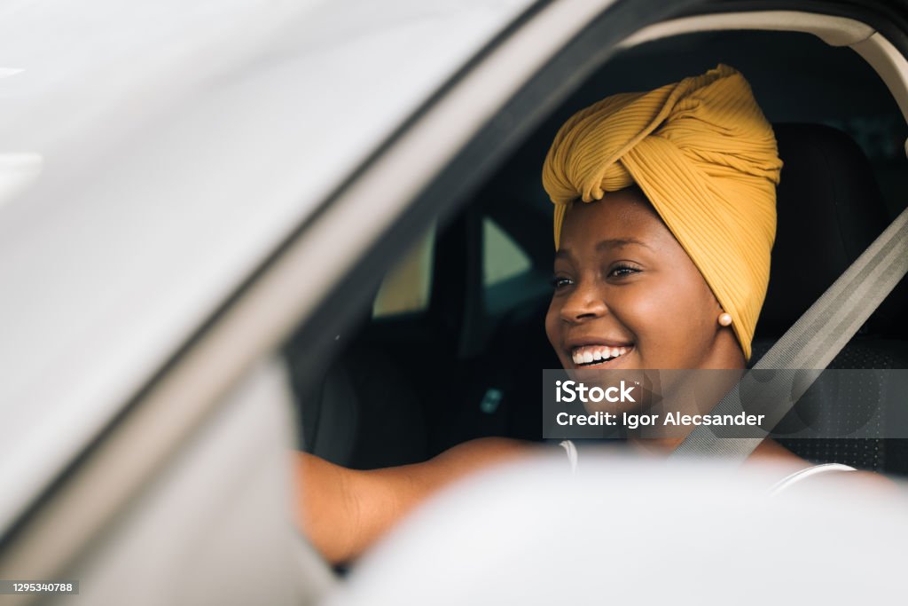African woman driving a car Driving Stock Photo