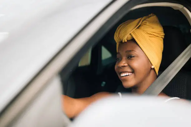 Photo of African woman driving a car