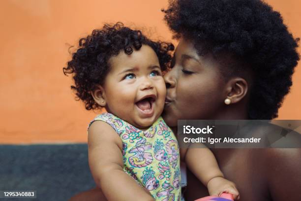 Mother Kissing Smiling Baby Girl Stock Photo - Download Image Now - Baby - Human Age, Mother, Family