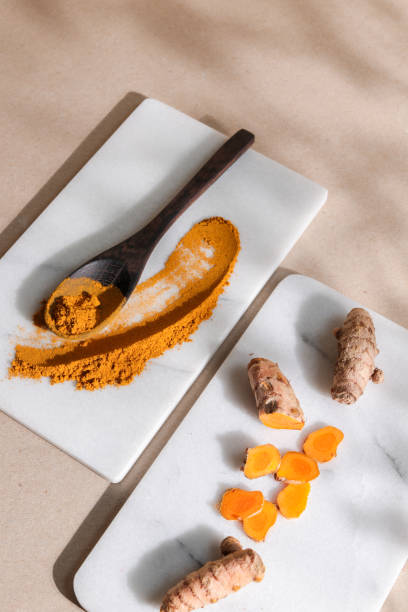 istock Organic Tumeric Kurkuma Root and Powder in bright background 1295342612
