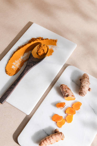 istock Organic Tumeric Kurkuma Root and Powder in bright background 1295342618