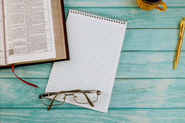 istock Cup of coffee while reading on Christian Holy Bible 1295348312