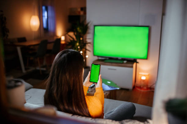 Woman sitting on couch with mobile phone