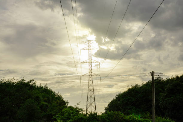 istock Electricity pole with silhouette sunset sky 1295351103