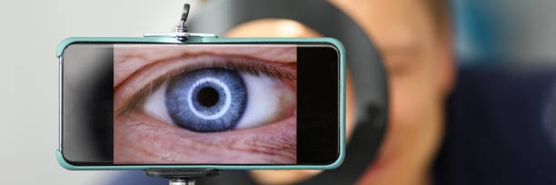 istock Man making video trying to shoot his own eye using modern smartphone camera 1295356889