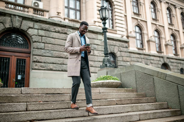 istock Young African American businessman using a smart phone 1295360881